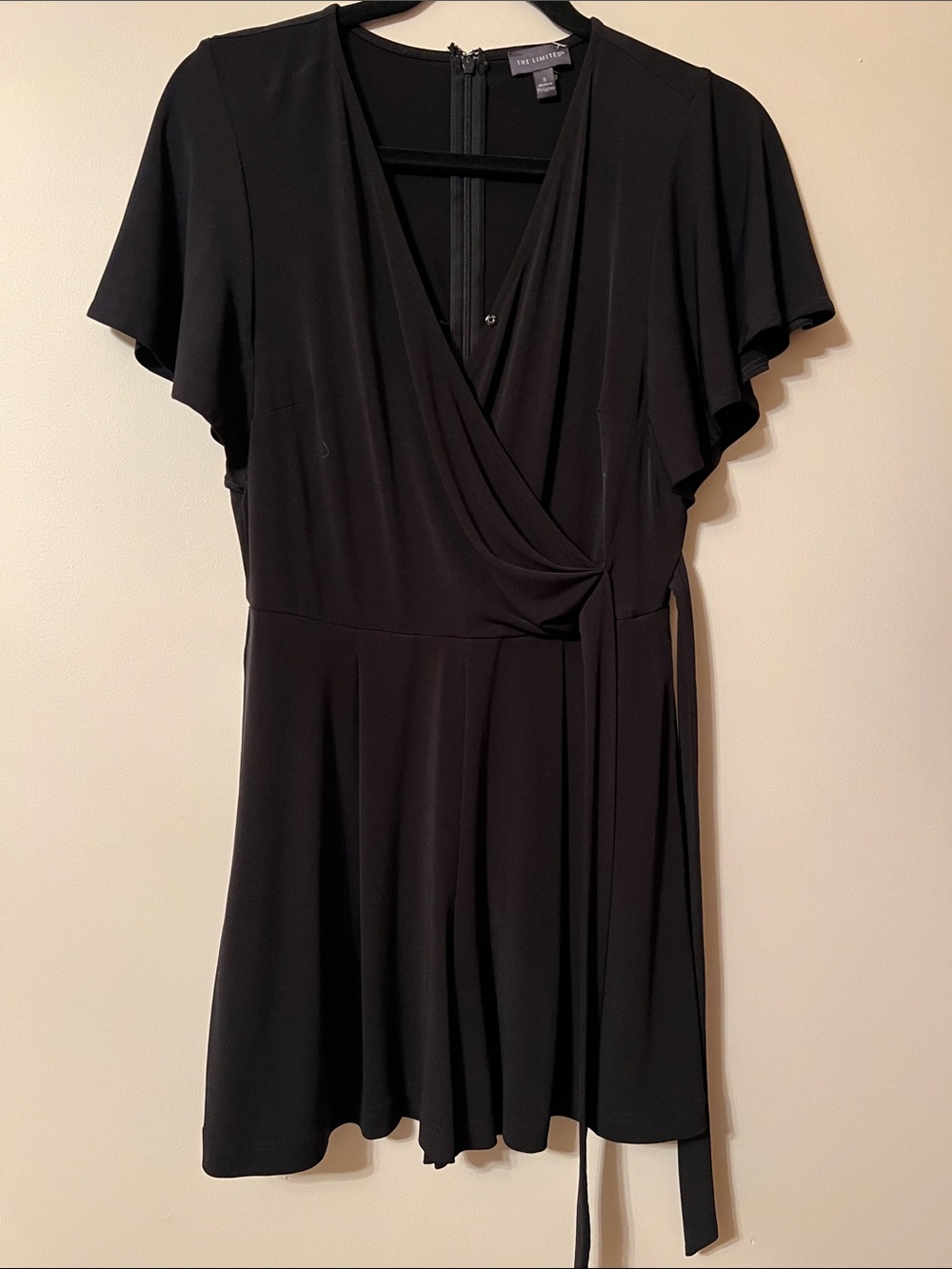 The Limited Black Faux-Wrap Flutter Sleeve Mini Romper!